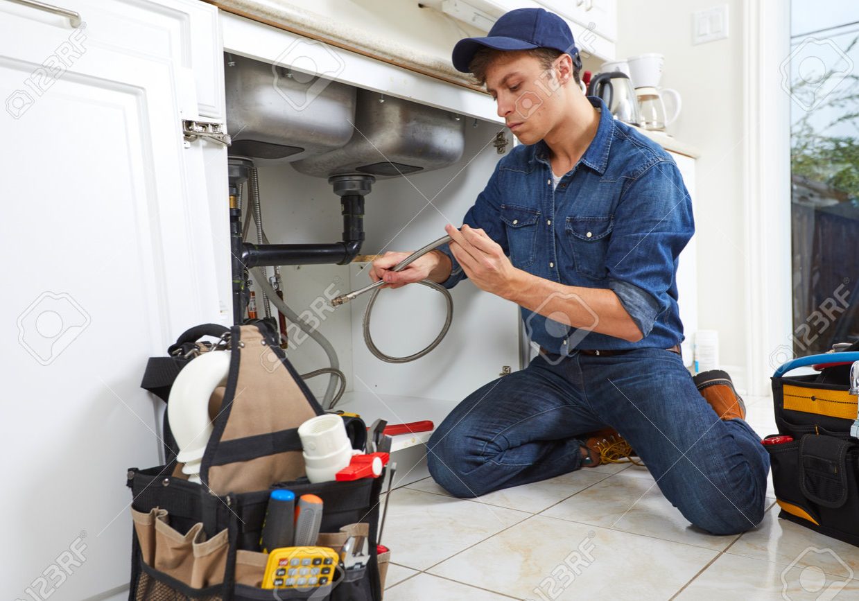 65963188-professional-plumber-doing-renovation-in-kitchen-home