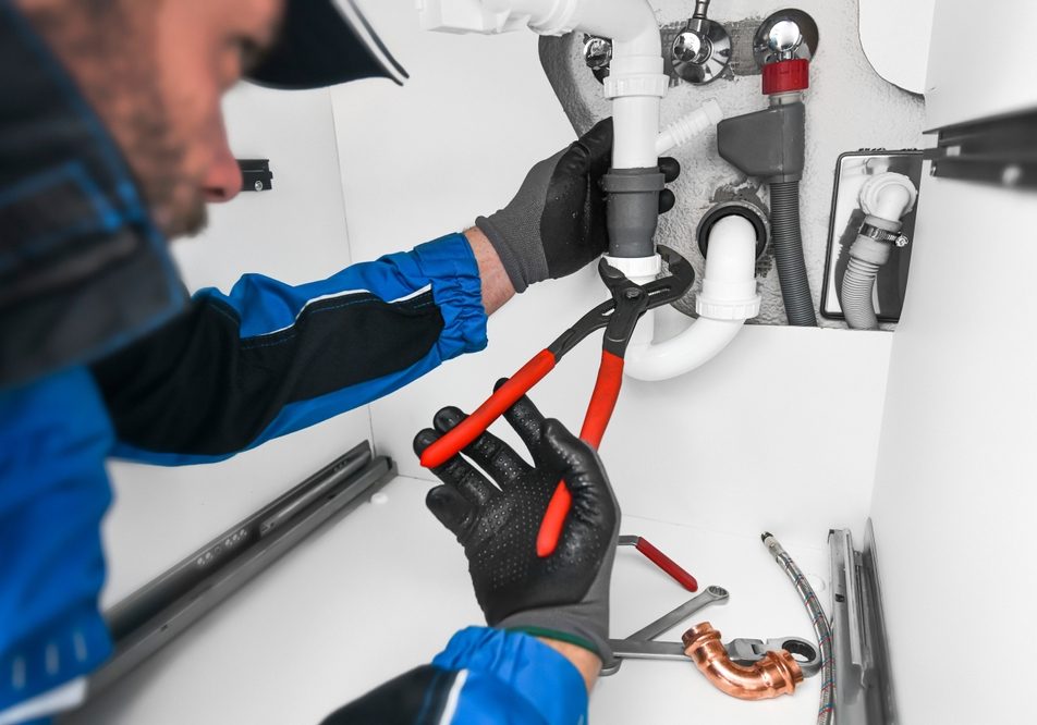 Plumber,Working,In,Kitchen,,Repair,Man,Service,,Repairing,Leaking,Water Plumber,Working,In,Kitchen,,Repair,Ma