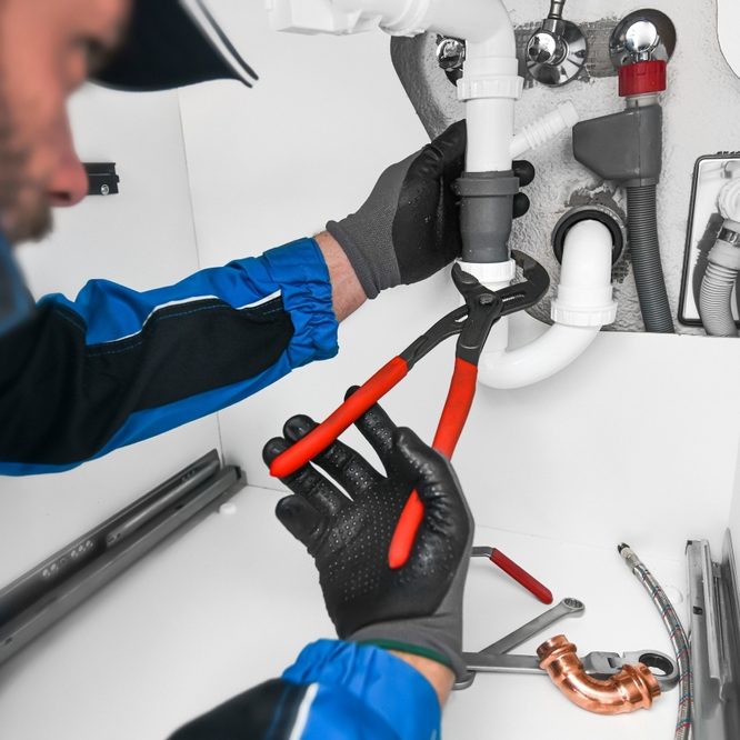 Plumber,Working,In,Kitchen,,Repair,Ma